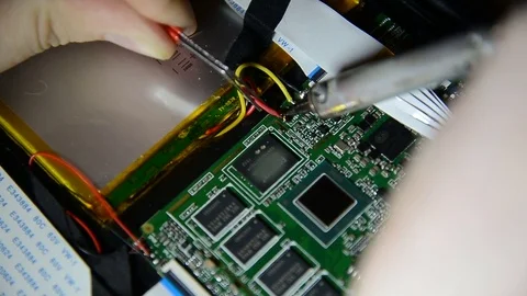 Electronics engineer is soldering an electric board with processors in a dark Stock Footage 73503170