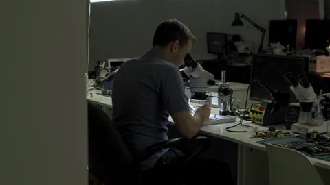 Electronics engineer is soldering an electric board with processors Stock Footage 133000713