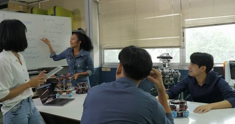 Electronics engineer team meeting, collaborating on construction of robot in the Stock Footage 94540161