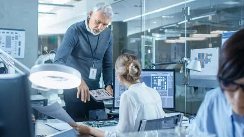 Electronics Engineer Works with Robot, Manipulating its Responses Laptop 写真素材