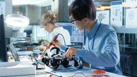 Electronics Engineer Works with Robot, Soldering Wires and Circuits Stock Footage 85768756
