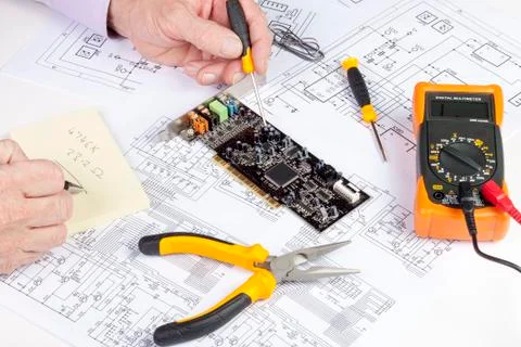 Electronics engineer writing on a note pad Stock Photos