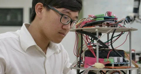 Electronics engineers works with robotics prototype in workshop. Stock Footage 111829365
