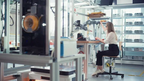 Electronics Female Engineer Works With Robot Stock Footage 187572171