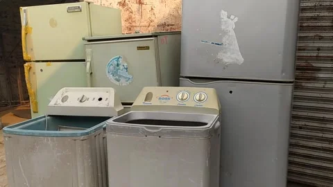 Electronics Junk - Closseup Of Old Refrigerator And Washing Machines Video stock 252505173
