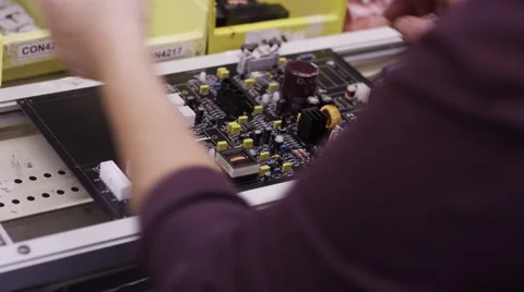 Electronics Manufacturing - Factory workers assembling circuit boards Stock Footage 48336428