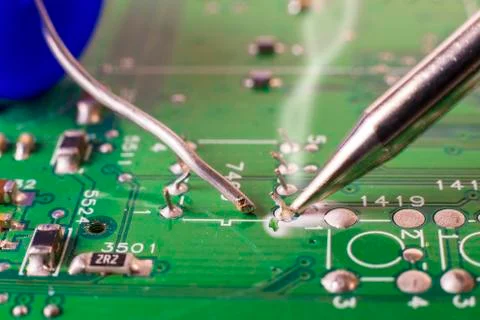 Electronics manufacturing services, soldering of electronic board. Stock Photos