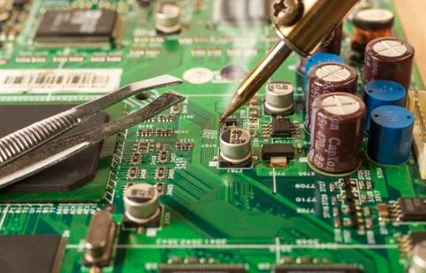 Electronics manufacturing services, soldering of electronic board. Stock Photos