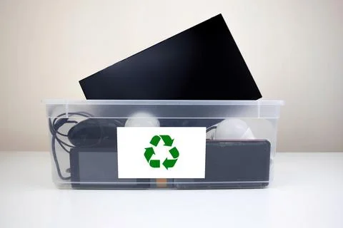 Electronics Recycling Bin With Various Devices and Batteries Stock Photos
