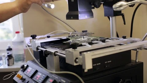 Electronics repair heats up the circuit for remove broken microchip Stock Footage 75832289