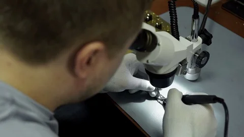 Electronics repair. Master repairs bad gadgets, smartphones. Stock Footage 73796791