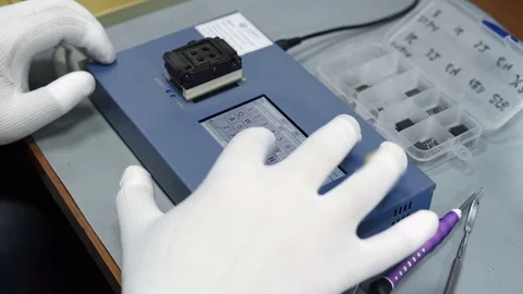 Electronics repair. Master repairs bad gadgets, smartphones. Stock Footage 73797413