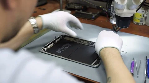 Electronics repair. Master repairs bad gadgets, smartphones. Stock Footage 73798887