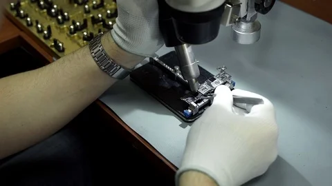 Electronics repair. Master repairs bad gadgets, smartphones. Stock Footage 73798917