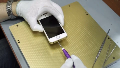 Electronics repair. Master repairs bad gadgets, smartphones. Stock Footage 73799001