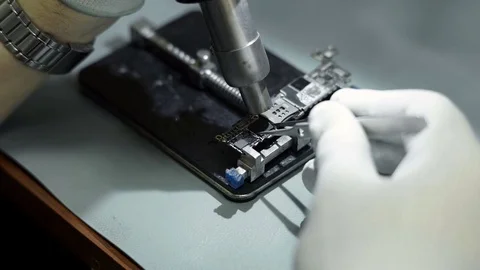 Electronics repair. Master repairs bad gadgets, smartphones. Stock Footage 73799057