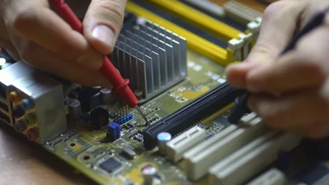 Electronics repair microchips and circuit boards at motherboard. service closeup Stock Footage 129509749