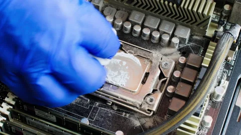 Electronics repair technician cleans the computer processor on the motherboard Stock Footage 156286322