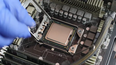 Electronics repair technician installs a computer processor in a motherboard Stock Footage 156274270