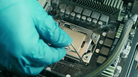 Electronics repair technician removes computer processor from a dust motherboard Stock Footage 156271567