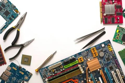 Electronics repair tools and circuit boards on work desk Stock Photos