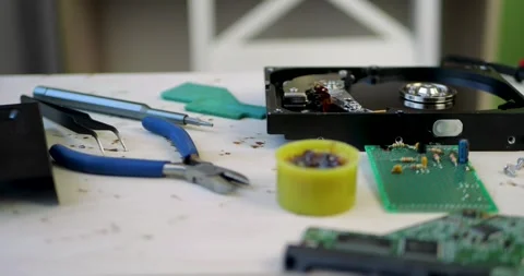 Electronics repair workstation with tools, components and hard drive on Stock Footage 348486929