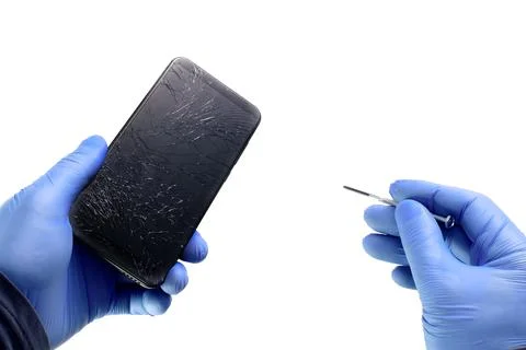 An electronics repairman holds a broken phone and a screwdriver on a white Foto stock
