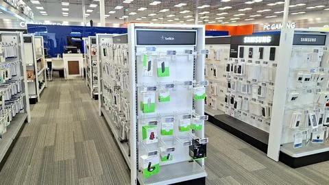 Electronics store aisles featuring shelves stocked with merchandise. Stock Photos