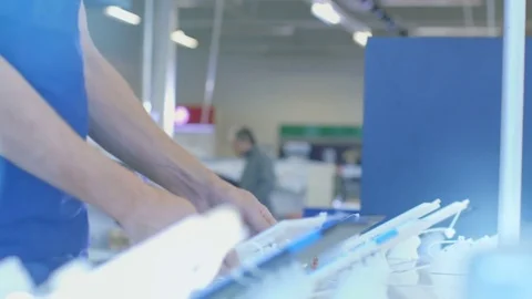 In the Electronics Store Young Man Looks for a New Tablet Computer To Buy. Video stock 79785600