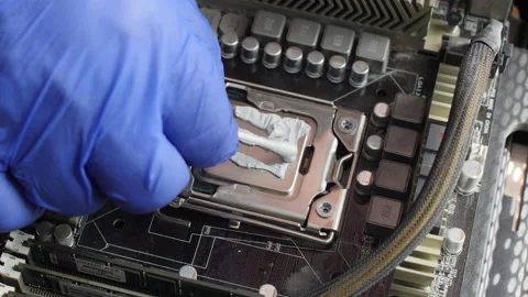 Electronics technician lubricates the computer processor on the motherboard Stock Footage 156377040