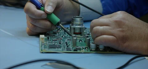 Electronics technician soldering computer board Video stock 90534485