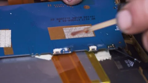 An electronics technician solders a broken tablet closeup Stock Footage 107565402