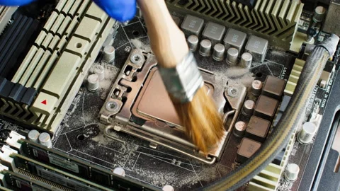 Electronics Technician sweeps dust off computer processor with a special brush Stock Footage 156377027