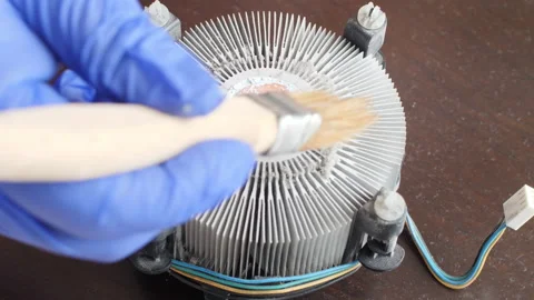 Electronics Technician sweeps dust off an heatsink a computer processor Stock Footage 156377060