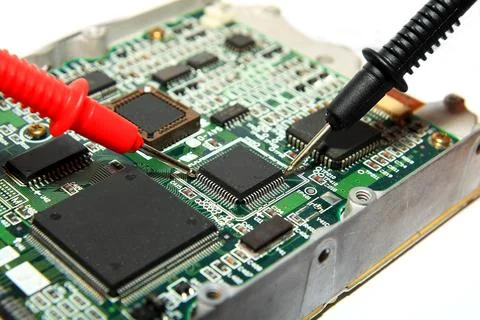 Electronics Testing on Circuit Board with Multimeter Probes Photos
