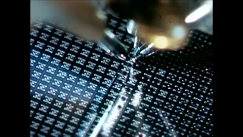 Electronics workers use microscopes and assemble components as an Electronic Video stock 92629578