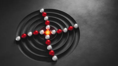 Electrons orbiting an atomic nucleus on a dark background Stock Footage 347877120