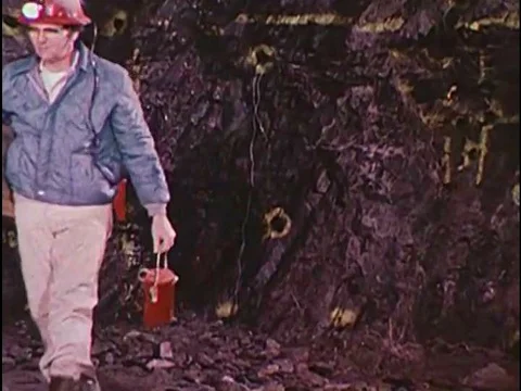 Electrostatic charges are dissipated with a hose in a mine in the 1970s. Video stock 74935546
