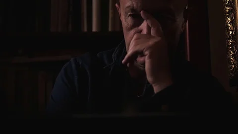 An elederly man is thinking something over in his study. Close up. Stock Footage 120486887