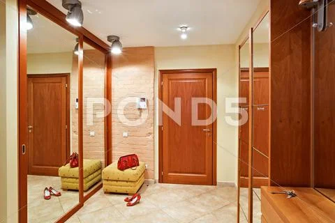 Elegance anteroom interior in warm tones with hallstand and mirror Stock Photos