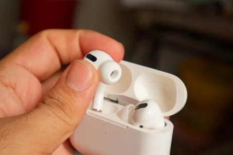Elegance in Hand: White AirPods Stock Photos