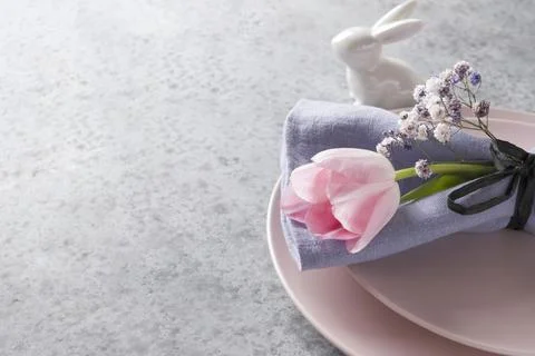 Elegance spring table setting with pink tulip on grey. Easter dinner. Stock Photos