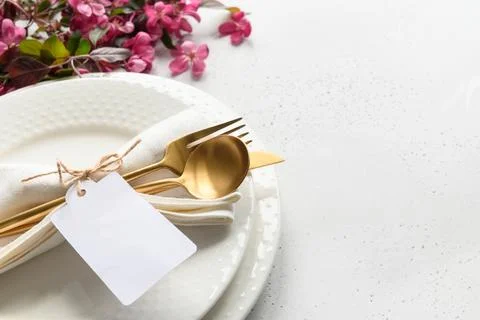 Elegance table setting with apple tree flowers on grey stone. Close up. Stock Photos
