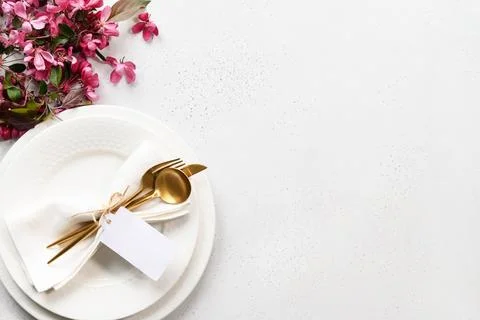 Elegance table setting with apple tree flowers on grey stone. Close up. Stock Photos