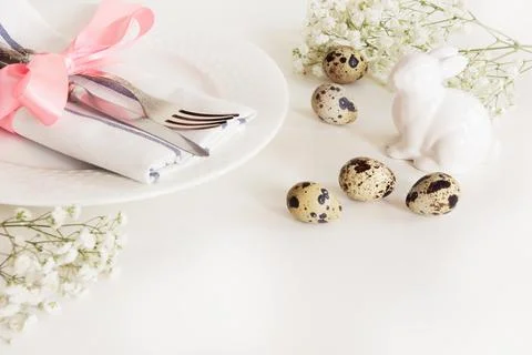 Elegance table setting with pink ribbon and flower. Easter romantic dinner. Stock Photos