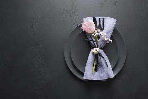 Elegance table setting spring pink tulip on black. Easter dinner. Top view. Stock Photos