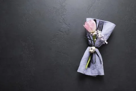 Elegance table setting spring pink tulip on black. Easter dinner. Top view. Stock Photos