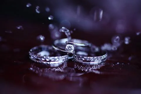 Elegance wedding ring shot with water drops. Stock Photos