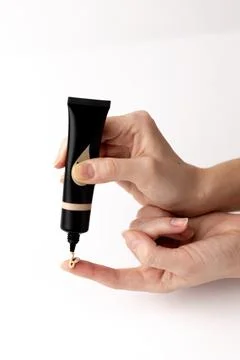 Elegant and Precise Application of Foundation in a Beauty Routine with a Sleek Stock Photos