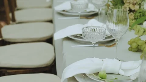 An Elegant and Tasteful Table Setting. Wedding decor, glass, flowers, candles Stock Footage 308397839